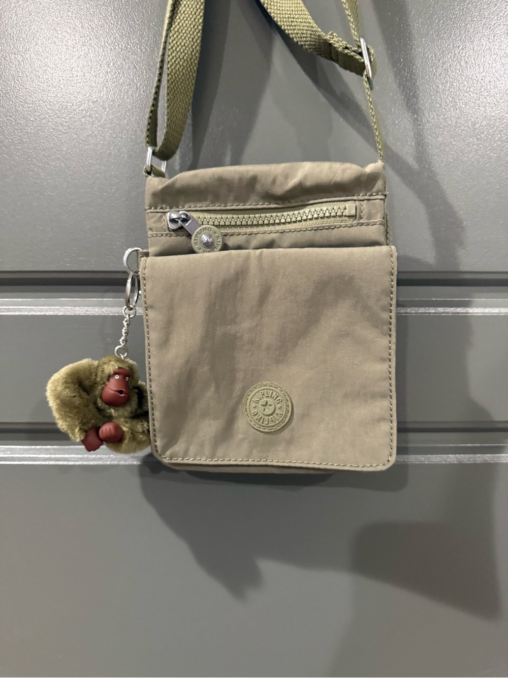 Kipling Olive-Tan Compact Crossbody Bag with Plush Monkey Charm
